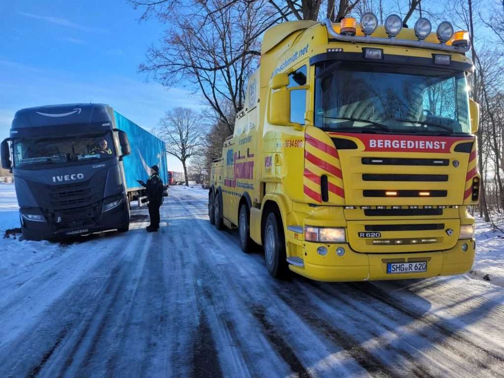 LKW steckt im Winter fest und wird abgeschleppt